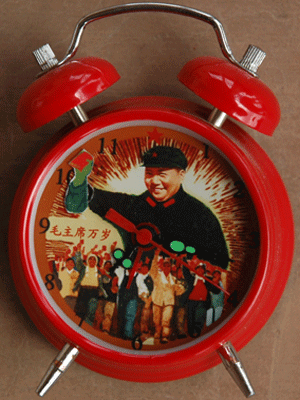 Mao waves his little red book of quotations,, in perfect time to the ticking of this precision timepiece.