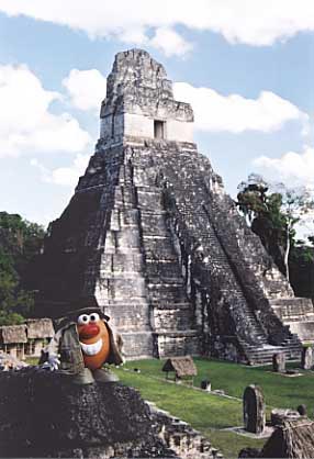 Spud  stands in Tikal's Grand Plaza with the Temple of the Grand Jaguar rising behind him from the forest floor.