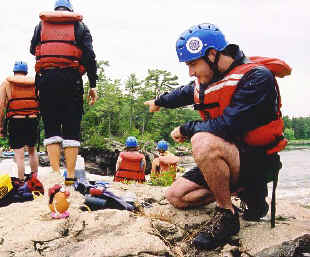 Spud discusses how to run the rapids with a fellow rafter