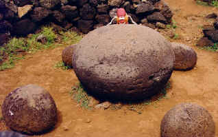 Spud tries to feel the energy of Hotu Matu'a's sacred rock: Te Pito te Kura